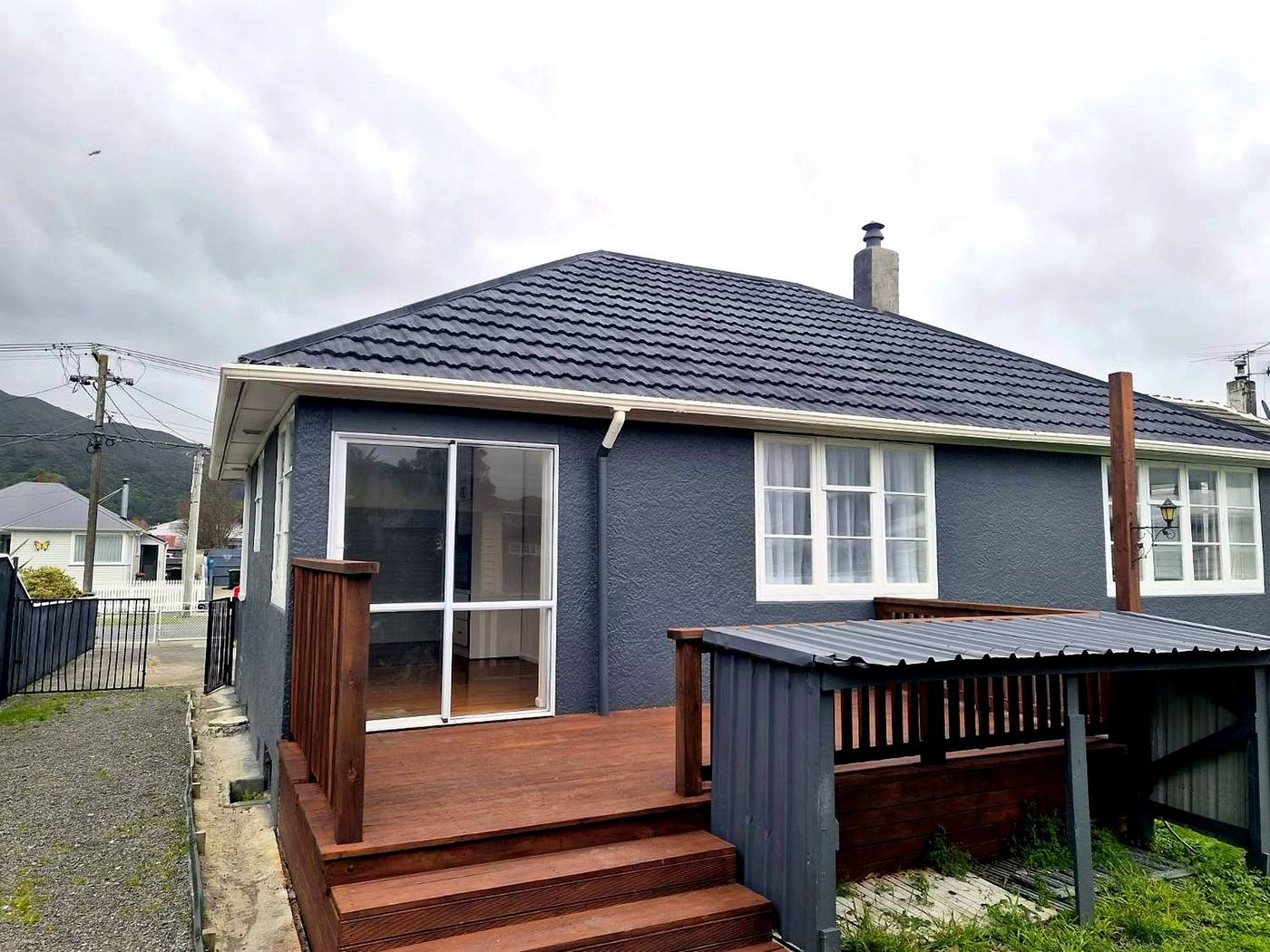 Rear of the grey bungalow after the new tile roof