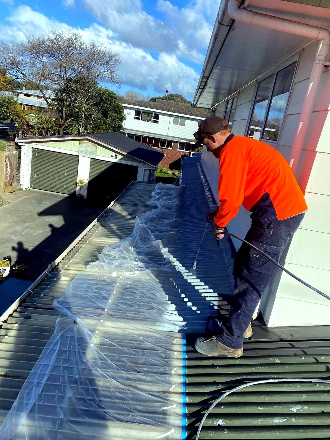 Spray coat going onto a roof